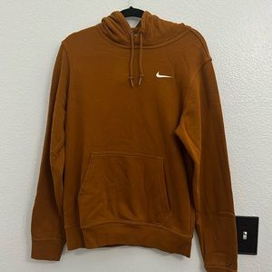 Burnt orange/brownish Nike hoodie.
